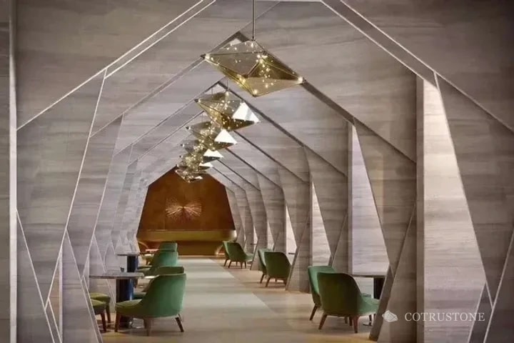 Geometric stone-clad portals with linear veining in an interior space