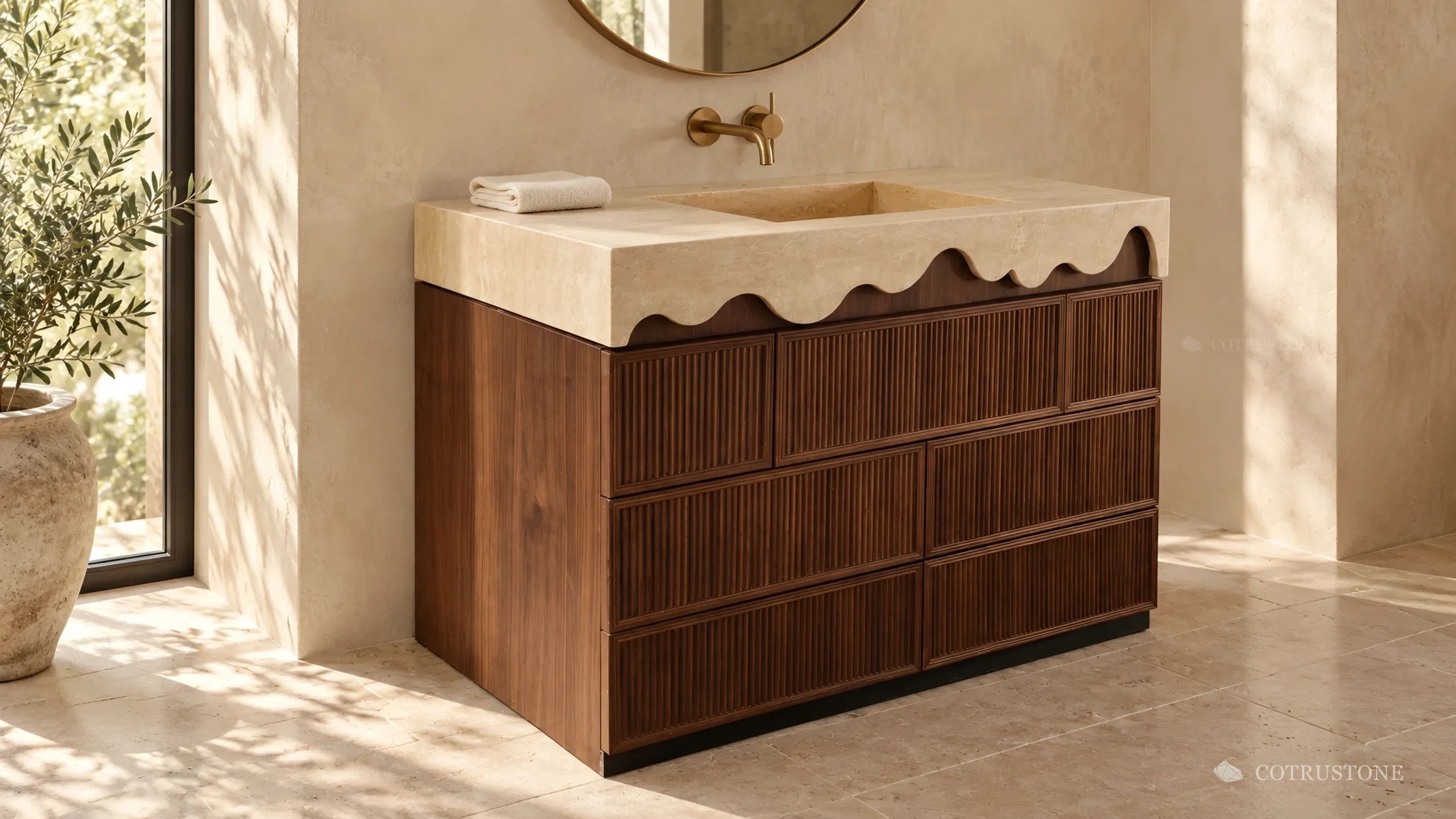 Stone vanity top with a wave-cut front edge and integrated basin over fluted timber drawers, in a sunlit bathroom